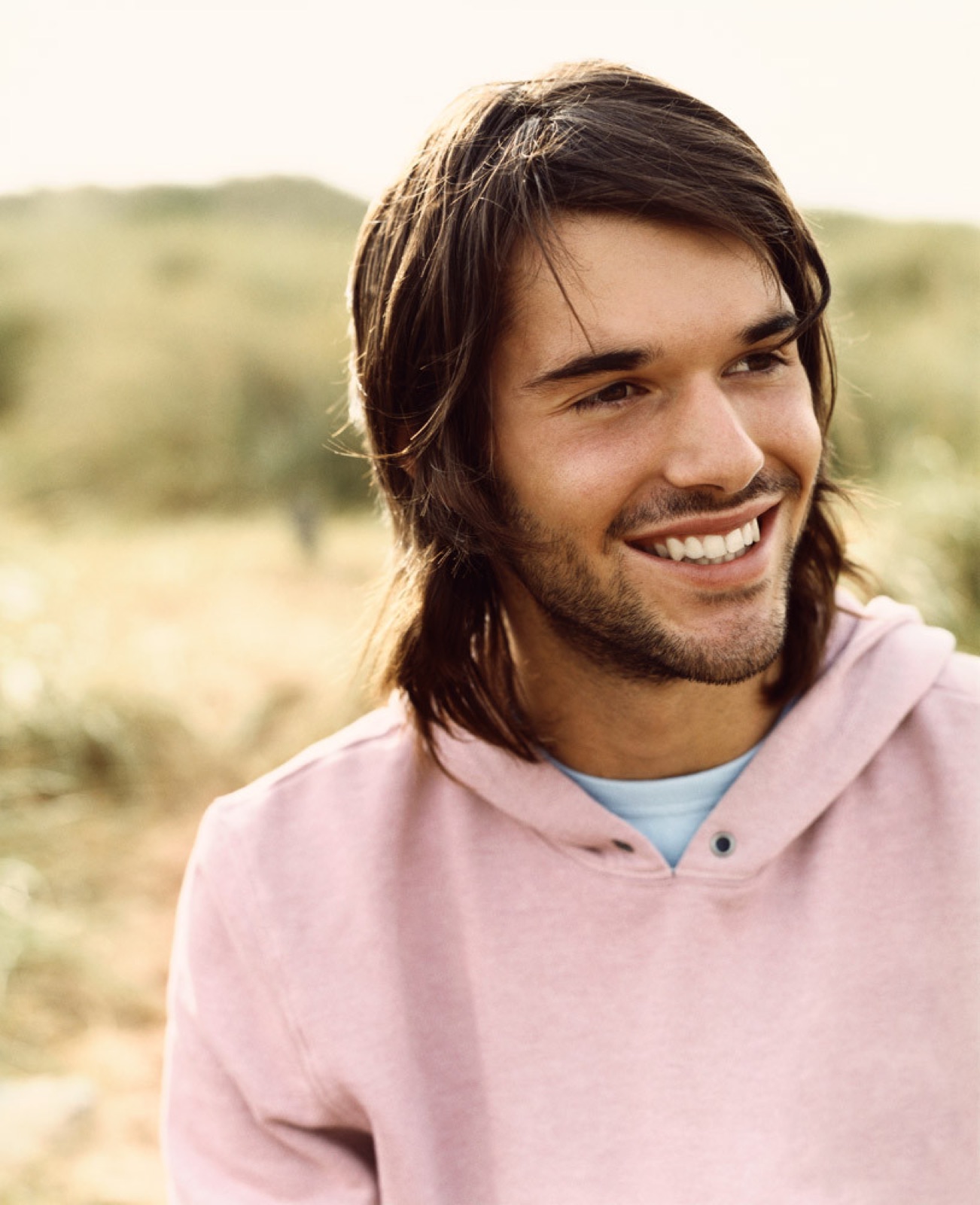 Young adult outdoors, smiling